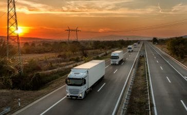 Fleet of trucks with driver monitoring systems on road