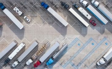 An aerial view image of a fleet of trucks on a parking lot