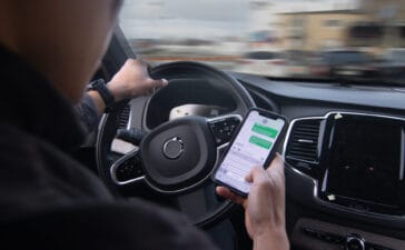 An image of a distracted driver texting behind the wheel